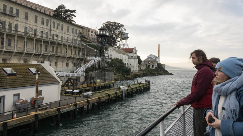 Tourists on boat looking at Alcatraz Island