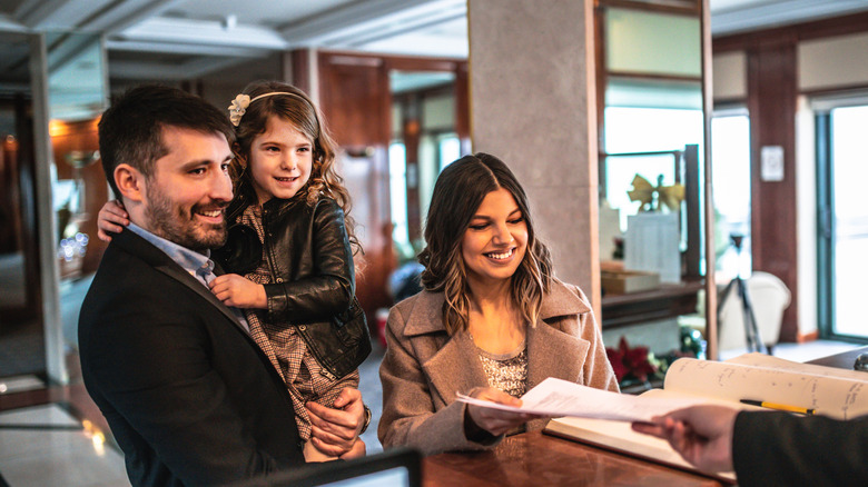 family checking into hotel