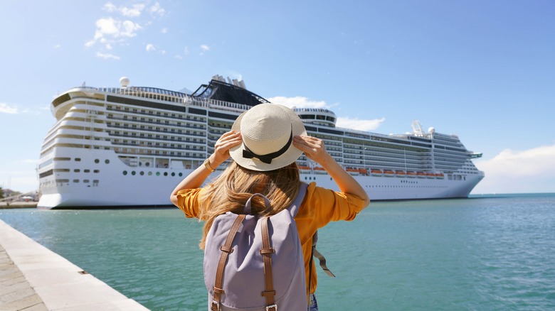 young woman on shore near cruise ship
