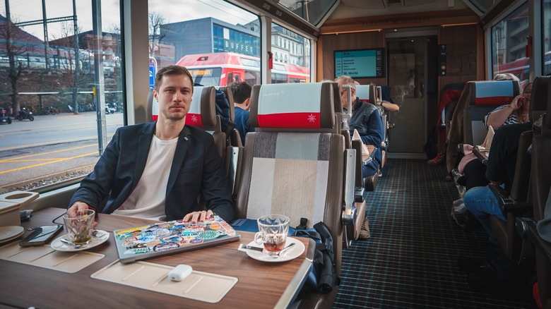 man at cozy train table, Europe 