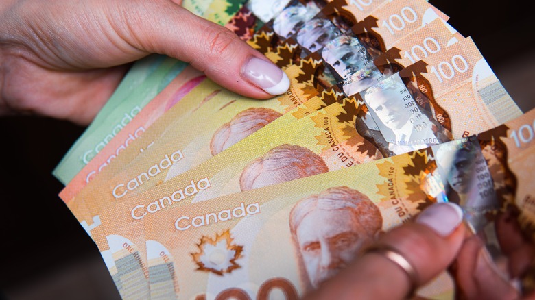 Canadian money in hand
