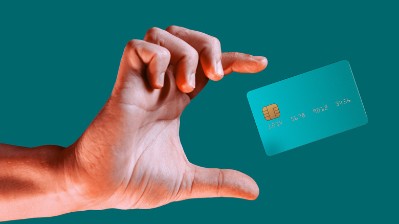 A hand and credit card