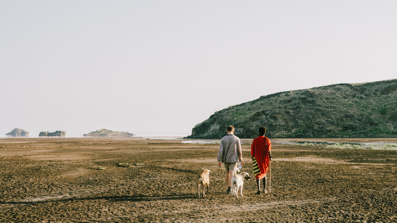 Tourist and Maasai man walking