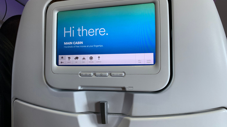 in-flight entertainment touch screen on back of plane seat