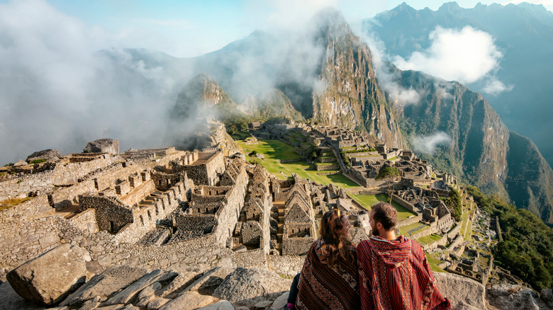 A couple looking at Machu Picchu ruins