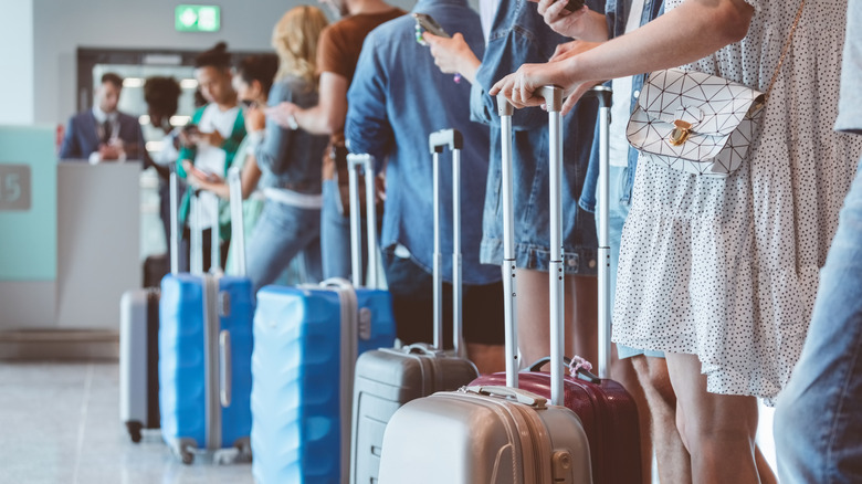 Passengers standing in line at boarding gate