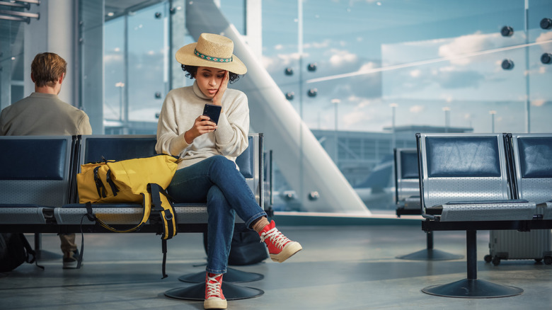 Woman sitting at boarding gate