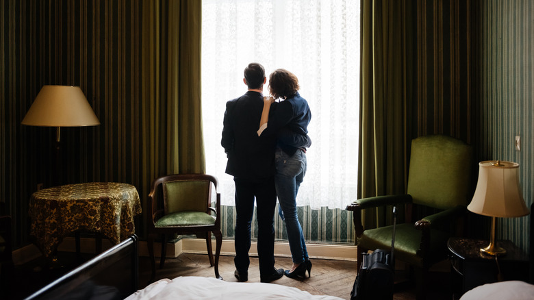 Couple looking through hotel window