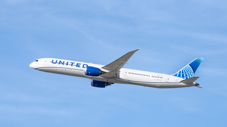 United Airlines plane shown flying in blue sky