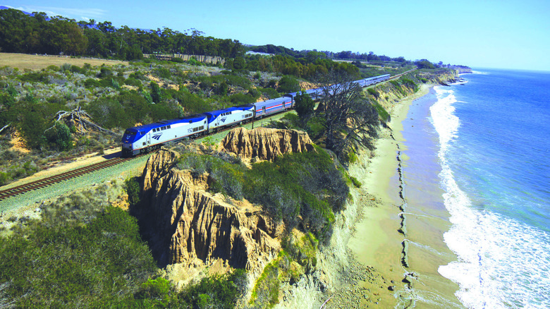 Amtrak train passing Pacific Ocean 