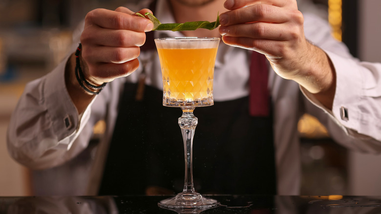 Bartender serving a pisco sour