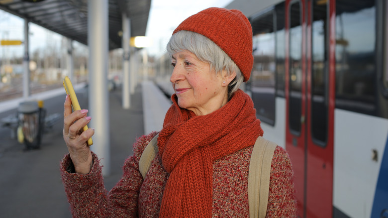 woman buying tickets on her phone