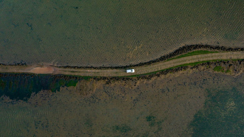 Drone view of car on Osea Island Causeway, United Kingdom