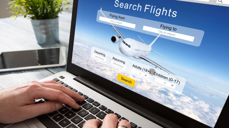 person booking flights on computer