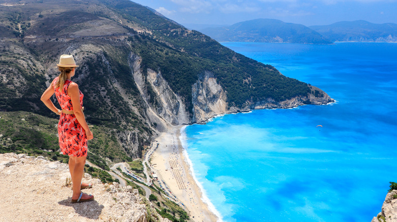 Woman in dress overlooking Myrtos Beach