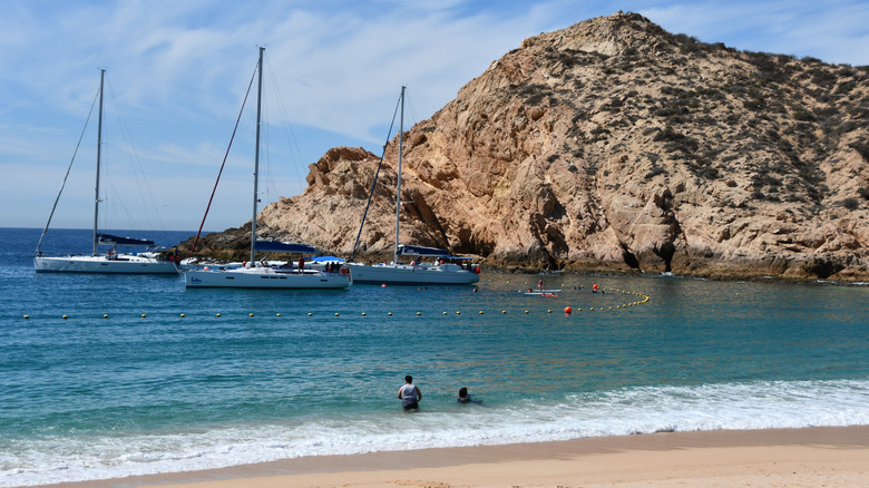 Cliffs, boats, blue ocean, beach