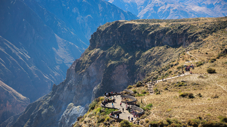 A lookout point at Colca Canyon is filled with people.