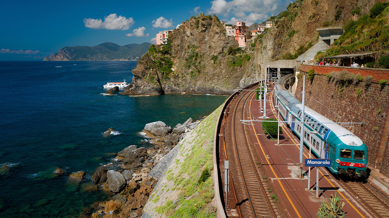 A train travels along the cliffside in Cinque Terre