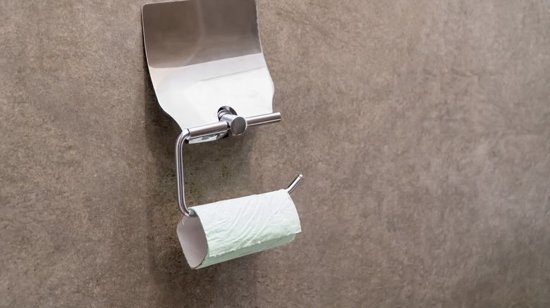 An empty toilet paper roll in a public bathroom