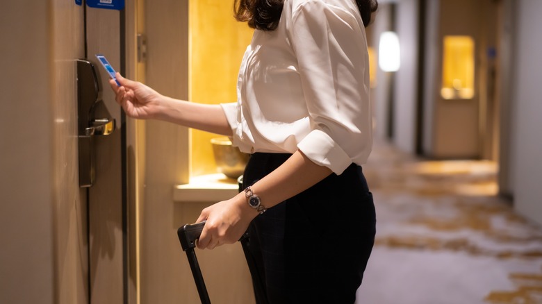 Woman unlocking door with keycard