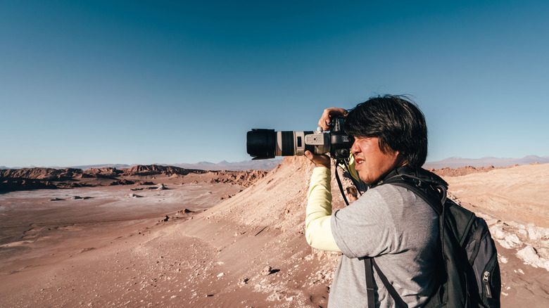 Man taking photos in desert