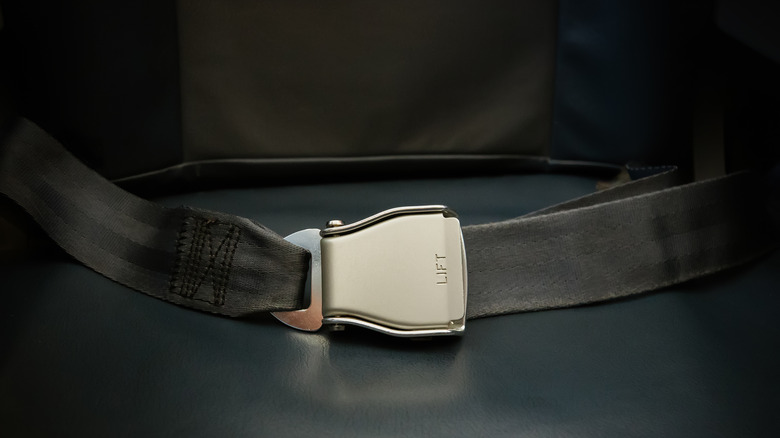 Fastened seatbelt on airplane seat