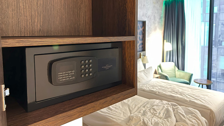 Digital hotel safe with beds in background