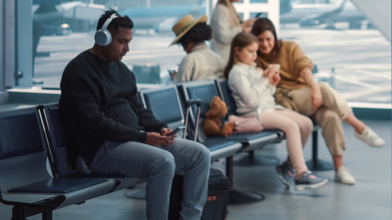 Wearing headphones at airport