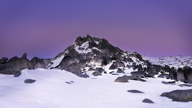 mountain peak sticking out of snow