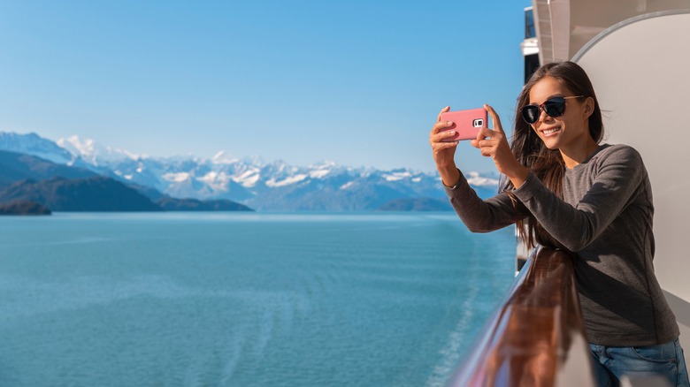 woman taking photo from ship