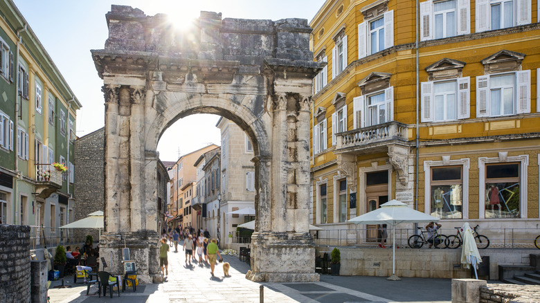 stone archway in busy street