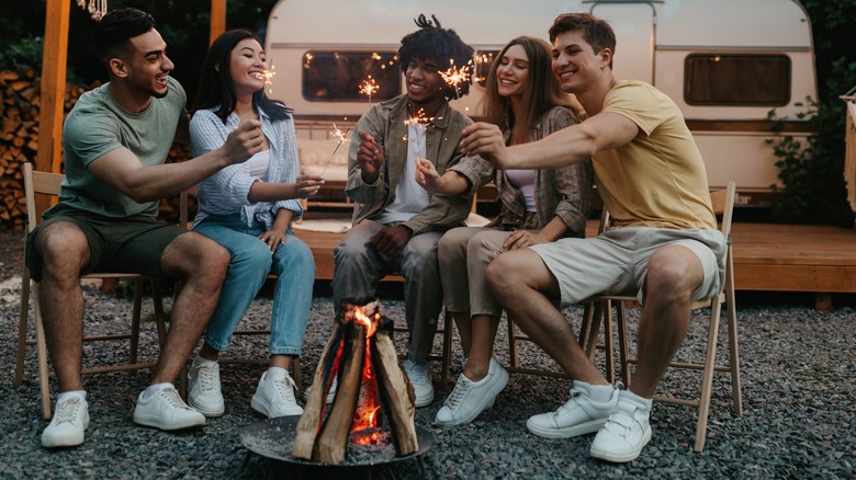Camping friends around a fire 