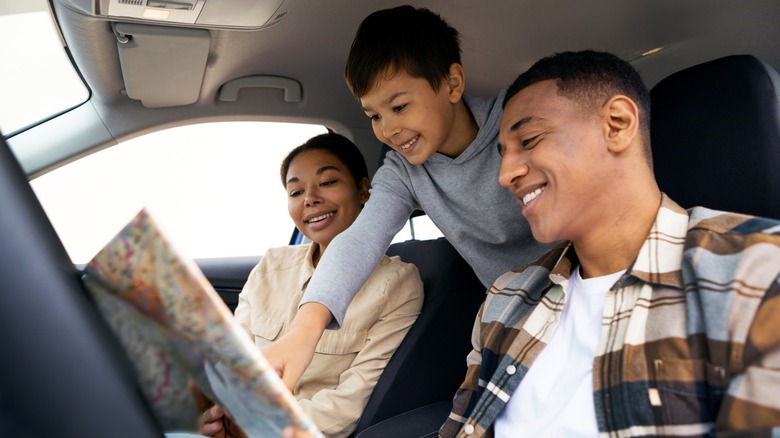 Family in car with map