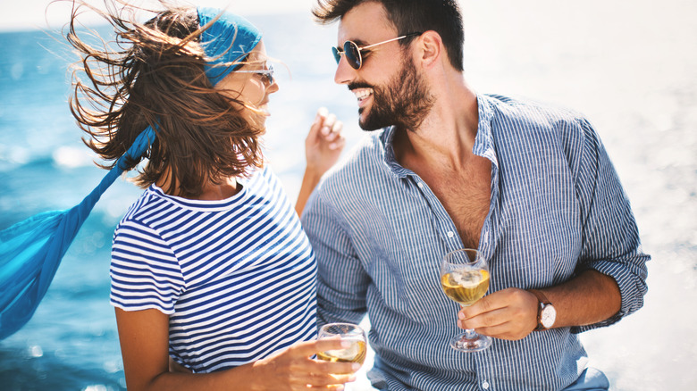 A couple enjoys glasses of wine on a cruise ship