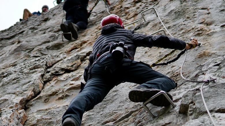 Climber grips cliff face at Nelson Rocks