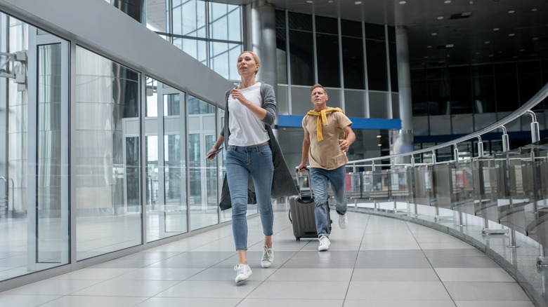 two people running through airport