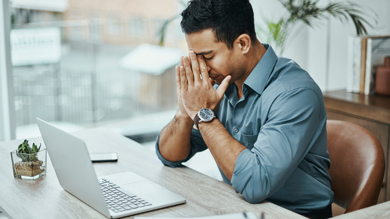 man stressed at laptop