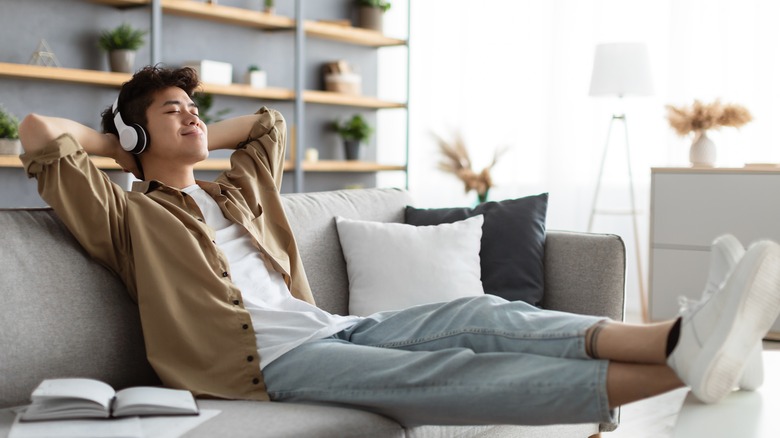 man leaning back with headphones