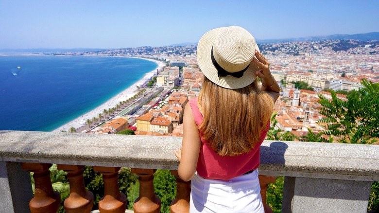 woman looking over water and city