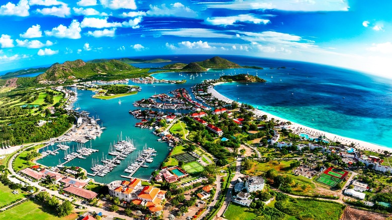 Caribbean island harbor with boats and a beach