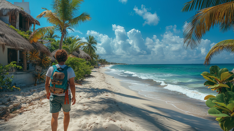 Man with backpack on beach in Mexico