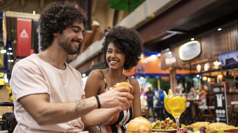 A couple eat at a restaurant in Brazil