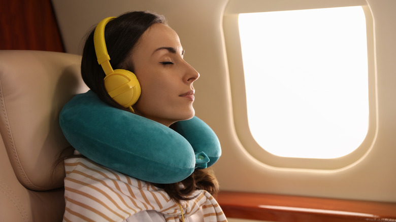 Woman asleep on plane