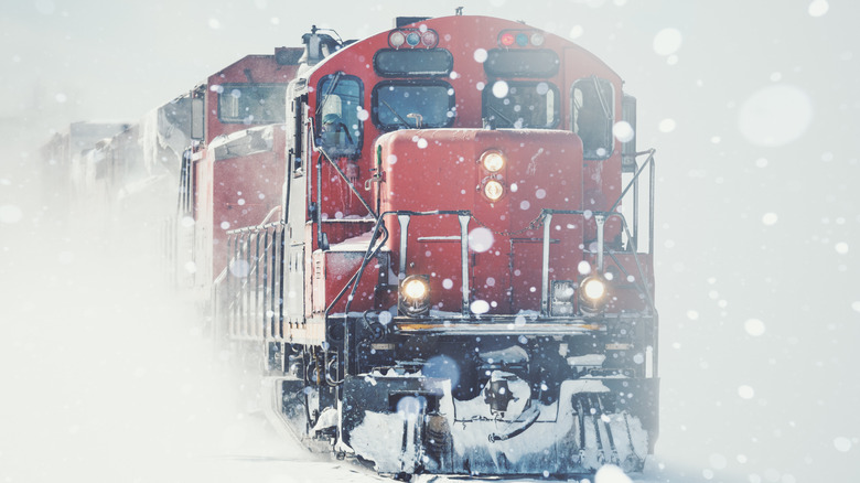 Red train through heavy snow