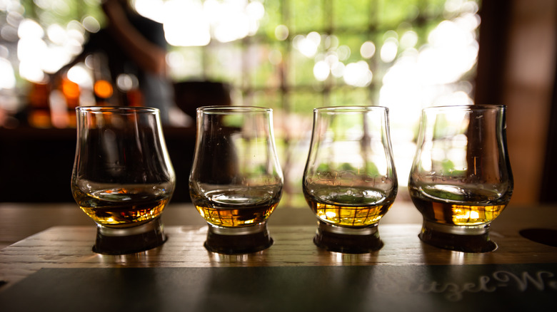 A flight of bourbon whiskey perches on a Louisville bar
