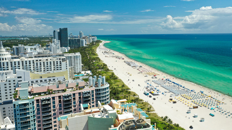 An aerial view of Miami beach sprawled between high rises and the ocean
