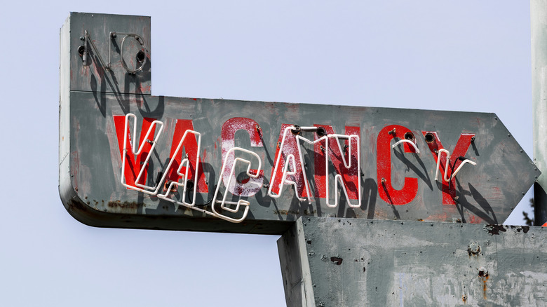 dilapidated motel vacancy sign
