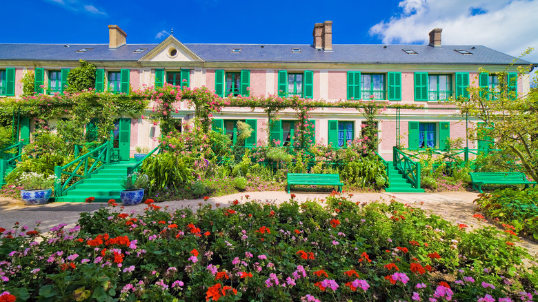 pink and green house with flowers