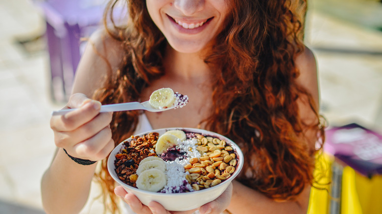 Woman eating acai bowl