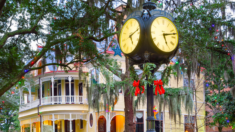 Victorian house and old clock in holiday decor